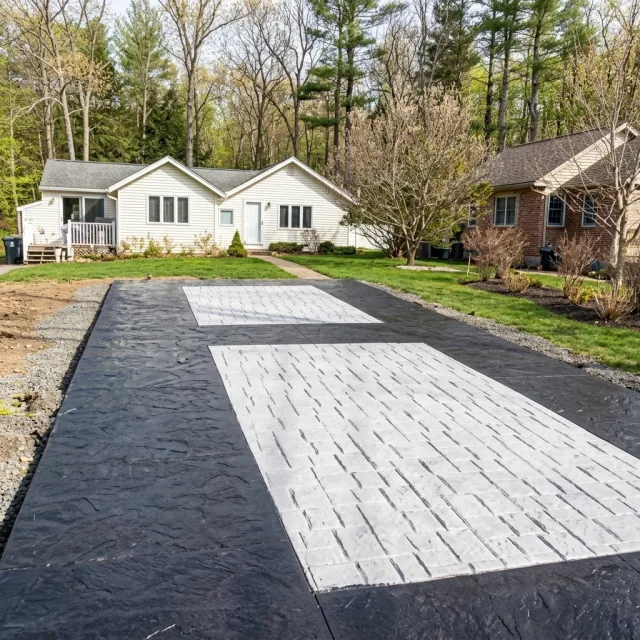 Large decorative concrete driveway with contrasting dark border