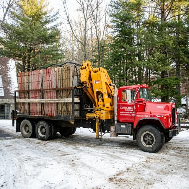 Sawyer Brothers red equipment truck carrying concrete forms